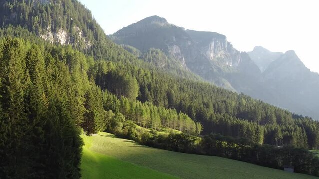 Mountains in Austria at dusk with meadows and forests in 4k