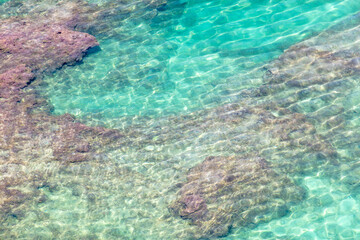 Turquoise water of the sea as an abstract background. View from above