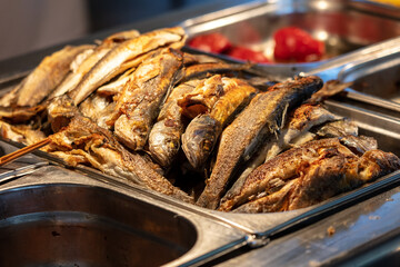 Fried fish on a tray in a restaurant