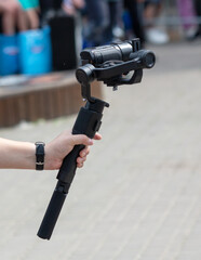 The operator shoots a video holding a professional video camera in his hands