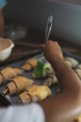 Hands making croissants, in the kitchen preparing for baking 