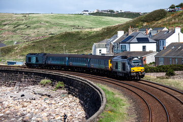 Obraz premium Passenger Train on the Shore of the Irtish Sea
