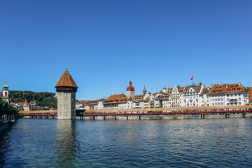 The Kapellbrucke (literally, Chapel Bridge), a covered wooden footbridge spanning the river Reuss diagonally in the city of Lucerne in central Switzerland