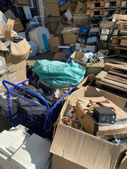 Sorting electronic waste for recycling. Cell phone photo of a warehouse.