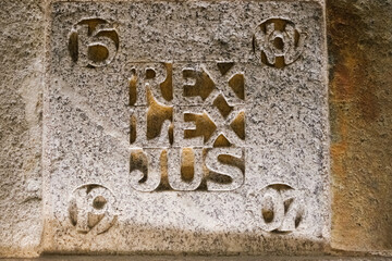 Inscription on a rock with the Latin motto REX LEX JUS, king law and jesus.