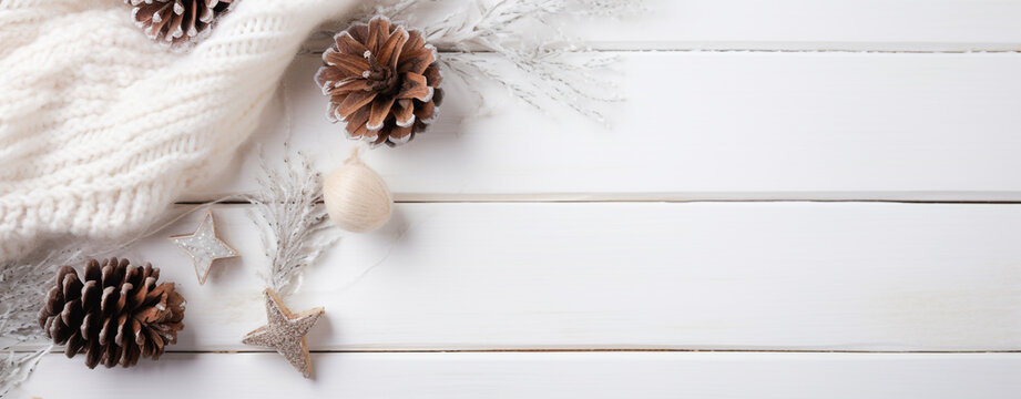 Christmas card with white wool scarf, fir cones and Christmas decorations on white wooden background with copy space, legal AI