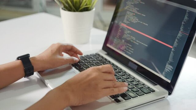 Programmer woman writing program HTML code sitting at workplace in office, IT software developer hands typing data coding programming with laptop computer, IT start up concept, Web application design