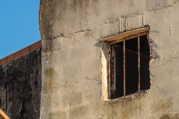 House window with iron bars resembles prison cell from street, from where every day there is less and less hope for release, review criminal case, acquittal and release. Innocently convicted concept