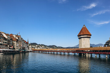 The Kapellbrucke (literally, Chapel Bridge), a covered wooden footbridge spanning the river Reuss diagonally in the city of Lucerne in central Switzerland
