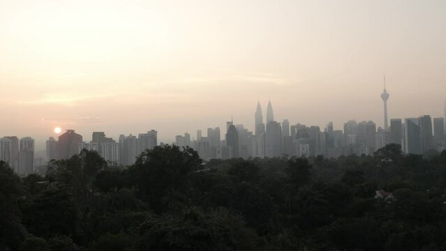 landscape view of kuala lumpur city center downtown district area with many skyscraper building highrise modern style towers with beautiful vanilla sundown sunrise