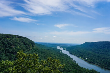 Fototapeta na wymiar Mountain valley and river, blue sky