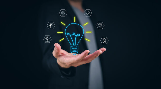 E-learning online graduate  graduate course concept man hand holding a light bulb showing the concept of learning ideas The Internet graduated for knowledge concepts starting with global creative expe