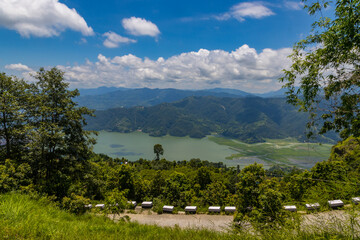 Beautiful Green Phewa Lake with Boats and Green Mountains in Pokhara City of Nepal during monsoon