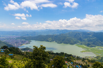Beautiful Green Phewa Lake with Boats and Green Mountains in Pokhara City of Nepal during monsoon