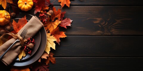 Autumn serving of plates on a wooden table, top view, autumn leaves and flowers
