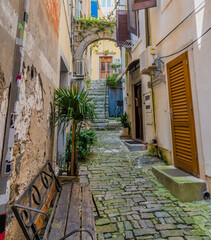Fototapeta na wymiar A view up a quiet backstreet in the old quarter of the town of Piran, Slovenia in summertime