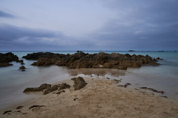 Long exposure of the rocks in the beach with a overcast sky