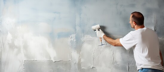 Leveling a wall with plaster Coating a concrete wall with a roller