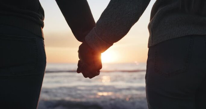 Silhouette, couple and holding hands, sunset at beach with love and bonding, commitment and romantic date outdoor. People in healthy relationship with adventure, support and trust, freedom in nature