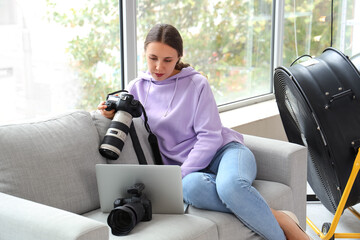 Female photographer with camera working in studio