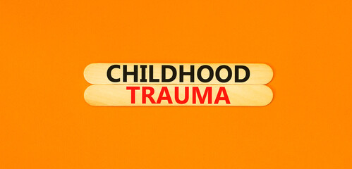 Childhood trauma symbol. Concept words Childhood trauma on beautiful wooden stick. Beautiful orange table orange background. Business psychology childhood trauma concept. Copy space.