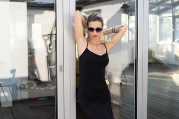 young beautiful woman posing in black dress in studio