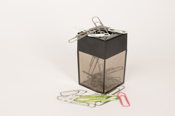 A Magnetic paper clip holder with clips all around it.