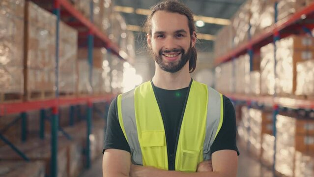 Happy professional worker looking at camera and smiling in the background warehouse with shelves full of delivery goods. Logistics, Delivery, and Distribution center.