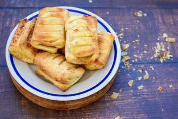 Fresh baked home made  Mini cheese puff pastries and cream  spread cheese.Cheese pie with phyllo pastry and herbs