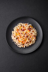 Delicious fresh Asian noodles with pieces of vegetables, meat, with salt, spices and herbs
