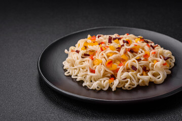 Delicious fresh Asian noodles with pieces of vegetables, meat, with salt, spices and herbs