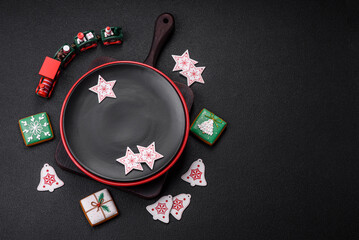 Empty ceramic black plate with christmas decoration elements