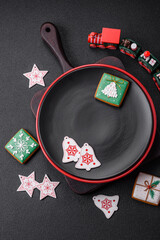 Empty ceramic black plate with christmas decoration elements