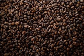 Horizontal beautiful view of dark brown fresh roasted coffee beans background. Copy space