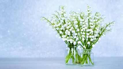 two bouquets of lilies of the valley close-up. festive background with bouquets of forest lilies of the valley.