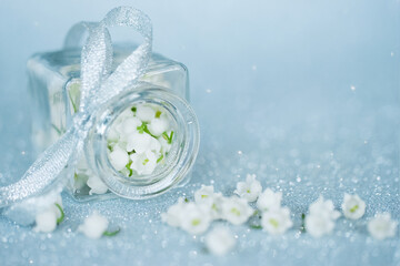 background with lily of the valley flowers. lilies of the valley in a vase and a copy of the space. a holiday card with lily of the valley flowers.