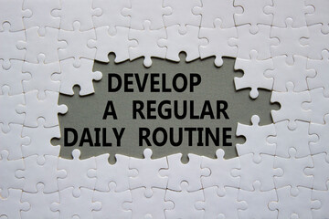 Daily routine symbol. Concept words Develop a regular daily routine on white puzzle. Beautiful grey background. Business and Develop a regular daily routine concept. Copy space.