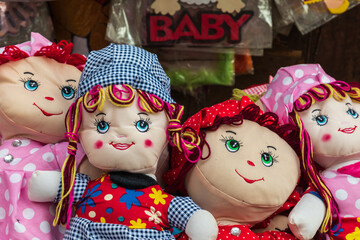 Cloth dolls for sale at an outdoor market.