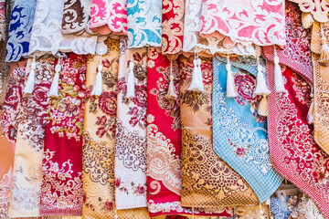Silk scarves for sale at an outdoor market.