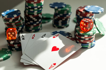 Studio shot composition of poker chips, dices, playing cards, coins and dollar banknotes isolated over white background.