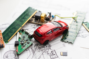 Toy cars on electronic board and microchip. Conceptual image for semiconductor shortage disrupting production of the automotive industry.