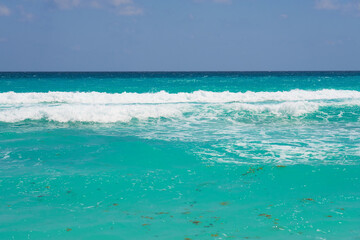 Waves with foam on the Caribbean coast in Mexico.