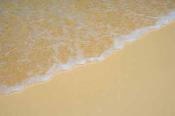 Waves with foam on the Caribbean coast in Mexico.