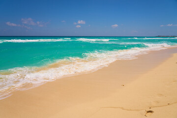 Waves with foam on the Caribbean coast in Mexico.