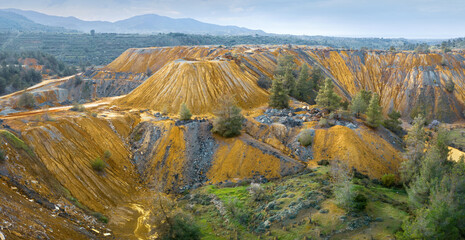 Panorama of vivid yellow tailings from abandoned Memi pyrite mine on Cyprus with area being...