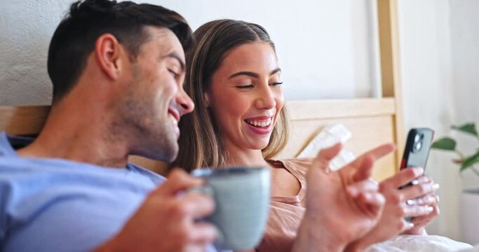 Coffee, phone and couple relaxing in bed on internet together on a weekend morning at home. Happy, smile and young man and woman drinking latte and scroll on social media with cellphone in apartment.