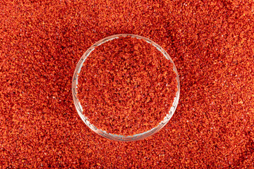 Dried red pepper flakes, chili pepper spice. Red pepper flakes. Heap of crushed peppers. Top view...