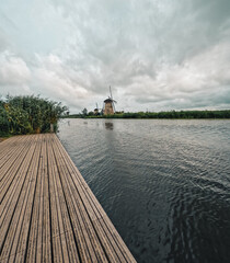 Iconic and historical wooden Dutch windmill and canal system. Built in the 1700's to keep water out of the low-lying areas, Kinderdijk, Netherlands has been a UNESCO World Heritage Site since 1997. 