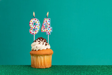 Birthday candles on green background.Birthday CupCake on bright green