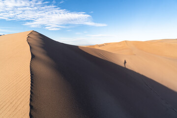 Fototapeta na wymiar Hiking in large sand dunes